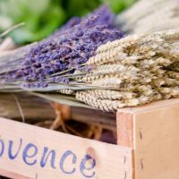 Wooden Box with the script text, Provence containing bunches of dried Provence Lavender and Dried Wheat stems tied in bunches, for sale at St Tropez market Cote D'azur